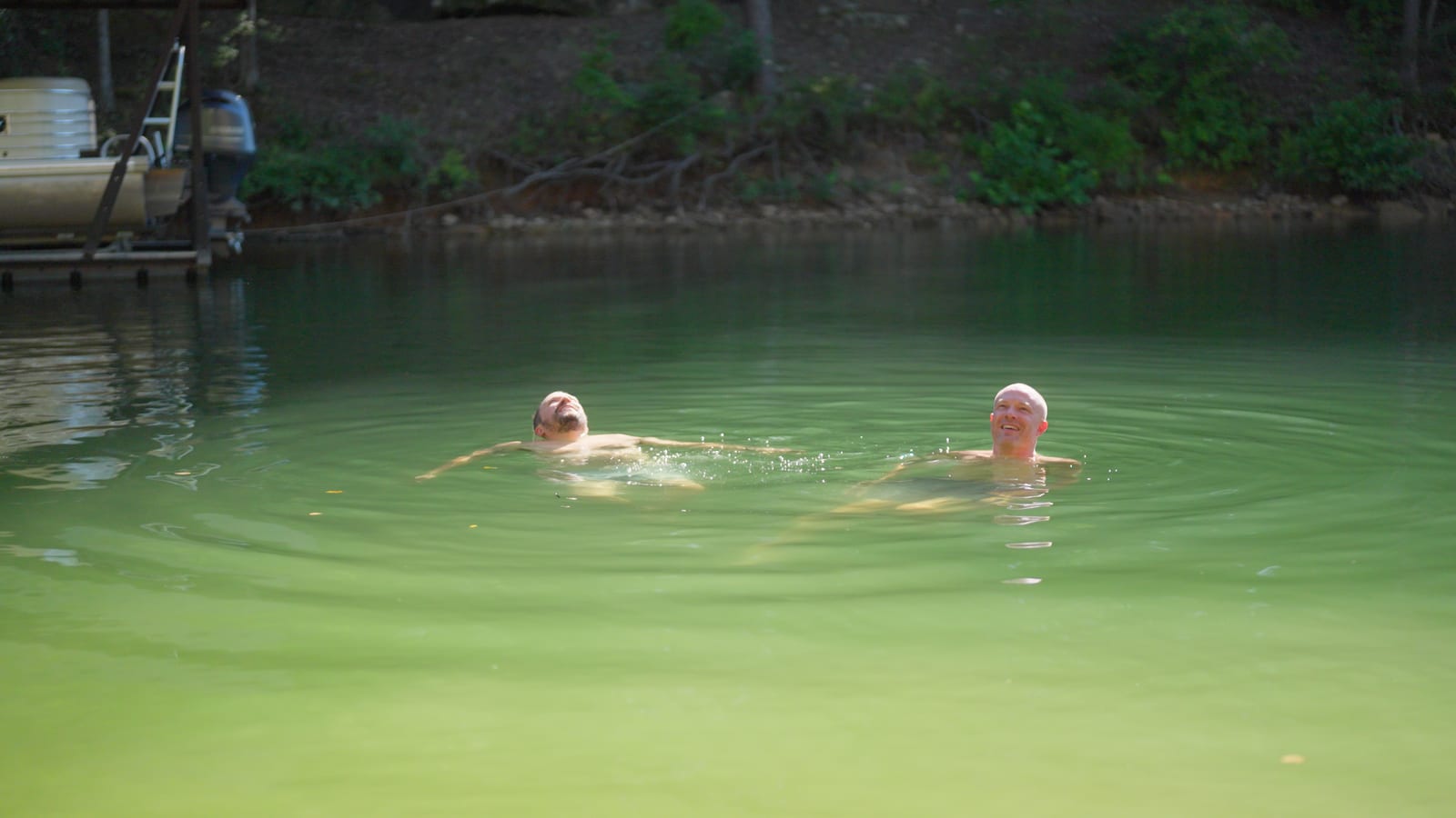 Two of the friends floating in the lake